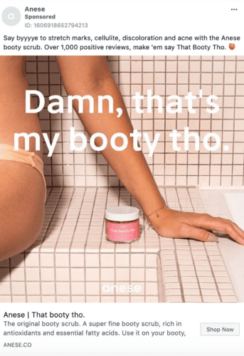 A woman sits on a light-colored surface with one leg bent. A jar labeled "That booty tho." sits beside her. Text overlay promotes Anese booty scrub.