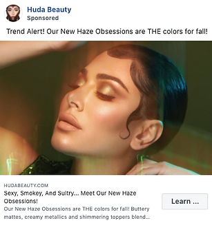 A woman with styled hair and glowing makeup poses with eyes closed against a green background, promoting Huda Beauty's new fall eyeshadow collection.