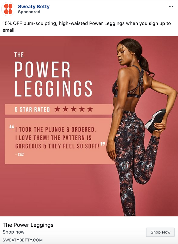A woman in patterned leggings stretches her leg in front of a sign promoting "The Power Leggings" with a customer review and a 15% off offer for signing up to email.