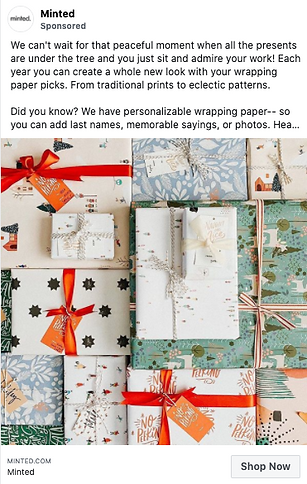A variety of wrapped presents in different patterned papers and red ribbons are stacked together, shown in a promotional image for Minted's personalized wrapping paper.