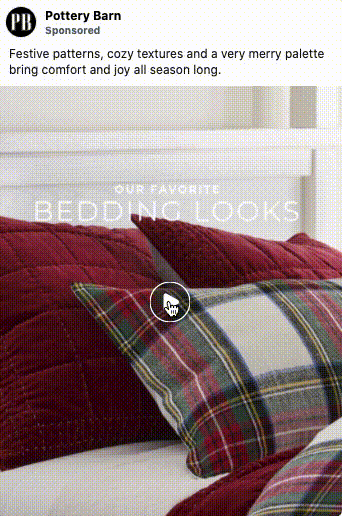 A bed with red and plaid pillows and a red quilt, showcasing festive bedding as part of a Pottery Barn advertisement.