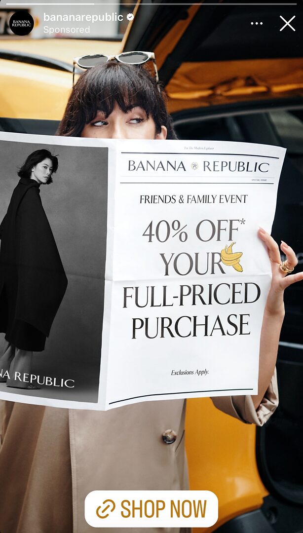 A person holds a Banana Republic flyer advertising a 40% off sale on full-priced purchases. The flyer features a model and text about a Friends & Family event.