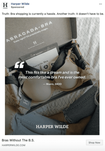 An open box with a beige bra, a Harper Wilde card, and a quote about comfort from a customer, placed on a bed with a quilted blanket.
