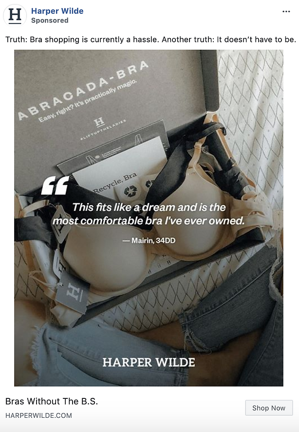 An open box with a beige bra, a Harper Wilde card, and a quote about comfort from a customer, placed on a bed with a quilted blanket.