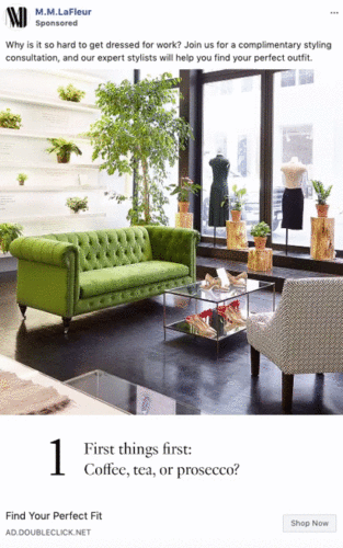 A modern boutique with a green velvet sofa, glass tables, plants, and mannequins displaying clothing near large windows.