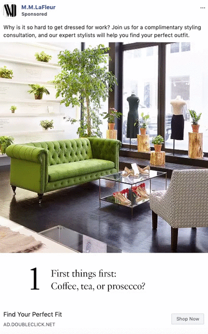 A modern boutique with a green velvet sofa, glass tables, plants, and mannequins displaying clothing near large windows.