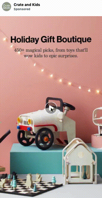 A display of kids' toys, including a white toy car, dollhouse, and chess set, is arranged in front of a pink wall with string lights. Text reads "Holiday Gift Boutique.