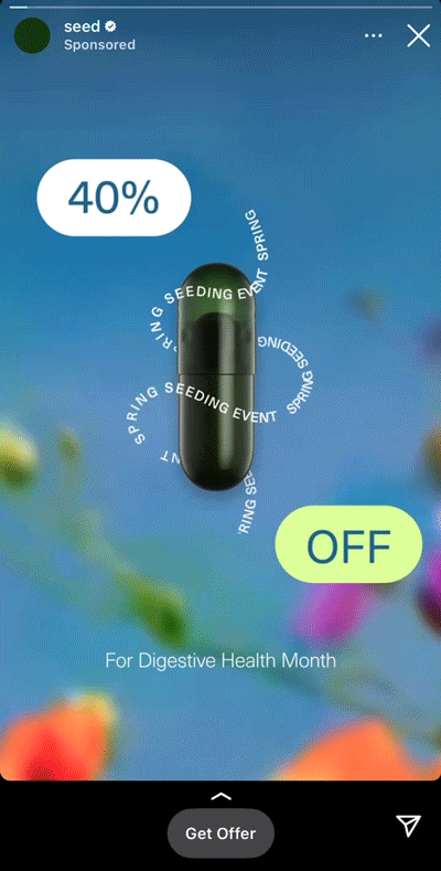 A black capsule with rotating spring event text, showing "40% OFF" for Digestive Health Month on a blue background with blurred flowers.