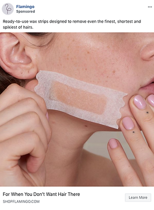 A person applies a rectangular wax strip to their cheek, demonstrating hair removal on facial skin.