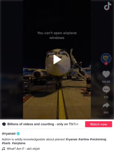 An airplane is parked on the tarmac at night, viewed from the front, with text overlay saying "You can't open airplane windows.
