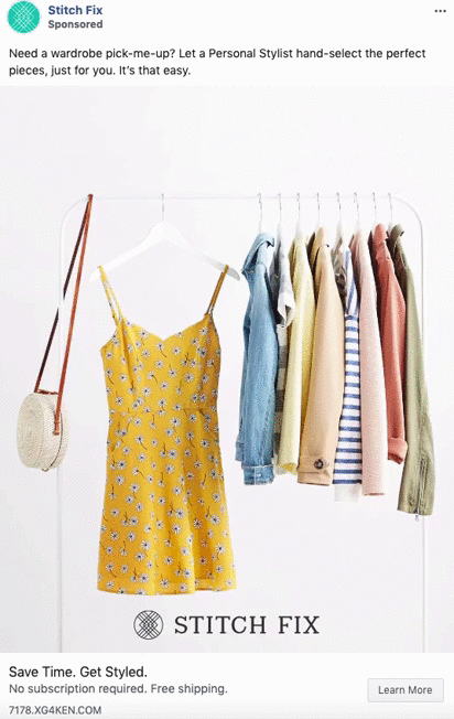 A yellow floral dress and various shirts and jackets hang on a white clothing rack next to a woven round bag.