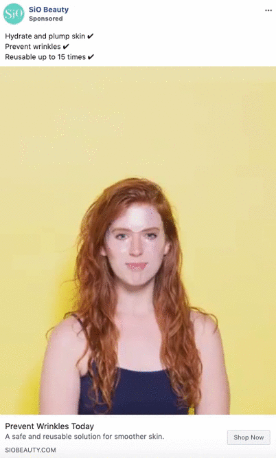 A woman with long red hair stands against a yellow background, smiling and touching her cheek, as text promotes SiO Beauty's wrinkle prevention products.