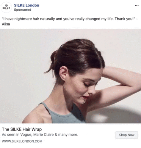 Woman with dark hair in a low bun wears a grey tank top and tilts her head down. The ad promotes the SILKE Hair Wrap, highlighting a positive customer testimonial.