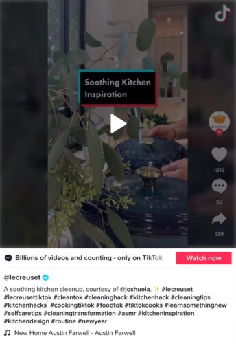 A TikTok video displays a person cleaning a kitchen sink with Le Creuset cookware, featuring the overlay text "Soothing Kitchen Inspiration.