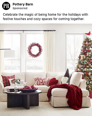 A living room decorated for the holidays with a Christmas tree, red and white pillows, a red throw blanket, a coffee table, and a wreath hanging in the window.