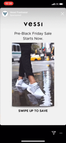 Person wearing white Vessi sneakers walks through a puddle on a city street. Text reads: "Pre-Black Friday Sale Starts Now. Swipe Up to Save.