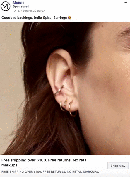 Close-up of a person's ear with three gold spiral earrings in the cartilage and no earring backings visible.