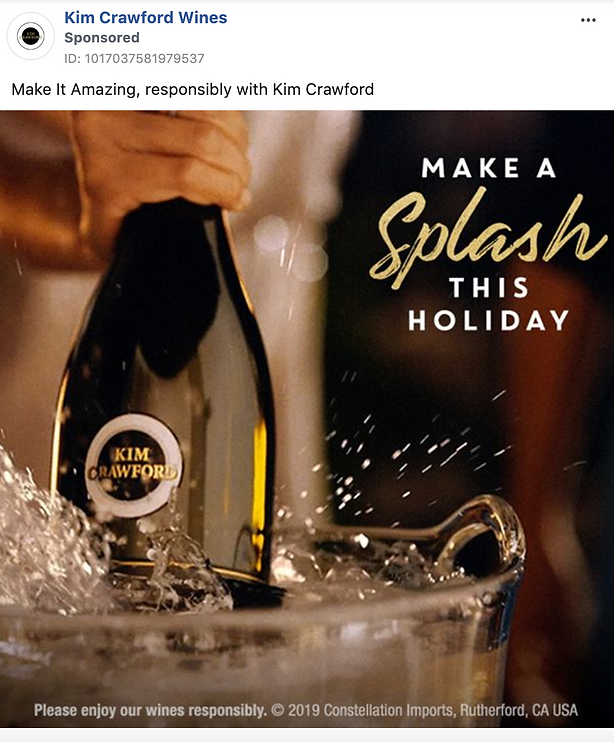 A hand holds a Kim Crawford wine bottle over an ice bucket, with the text "Make a Splash This Holiday" displayed beside it.