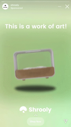 A rectangular device with a wooden base and white frame is displayed on a green background with the text "This is a work of art!" and the Shrooly logo below.