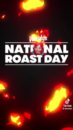 Wendy’s National Roast Day promotional graphic with flames and the Wendy’s logo, featuring a female emoji in front of bold text. TikTok watermark in the bottom right corner.