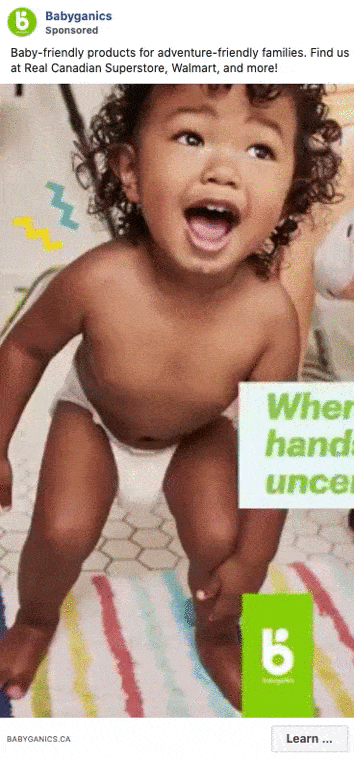 A smiling toddler in a diaper crawls on a colorful striped rug next to green Babyganics branding and text promoting baby-friendly products.