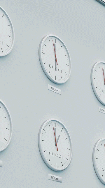 A wall display of six Gucci-branded clocks, each labeled with different city names, showing various times.