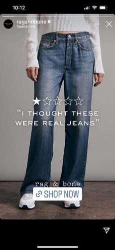 A person wearing high-waisted blue jeans, a white ribbed sweater, and white sneakers stands against a plain backdrop. Overlay text says, "I THOUGHT THESE WERE REAL JEANS.