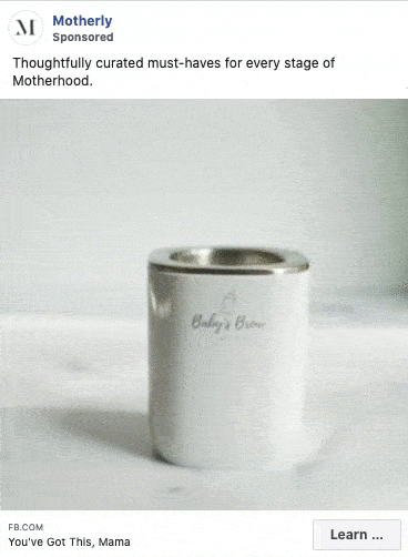 A stainless steel Baby's Brew bottle warmer displayed on a light surface, featured in a sponsored ad by Motherly for parenting essentials.