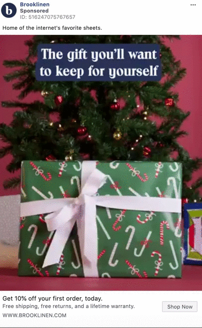 A Christmas tree with a large, wrapped gift box in front and a sign that reads, "The gift you'll want to keep for yourself.