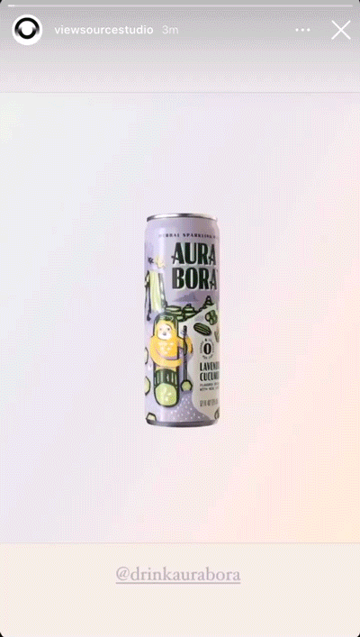 A can of Aura Bora lavender cucumber sparkling water is centered on a plain, light background.