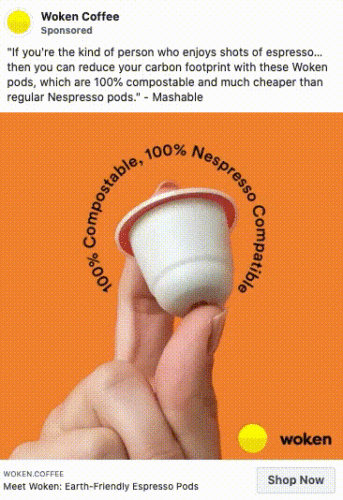 A hand holds a white coffee pod with a red rim against an orange background. Text reads: "100% Compostable, 100% Nespresso Compatible." Woken Coffee branding is visible.