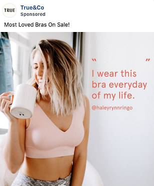 Woman in a light pink bra smiles while holding a white mug; text reads, "I wear this bra everyday of my life. @haleyrynnringo".