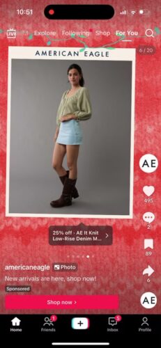 A woman models a light green blouse, light blue skirt, and brown boots against a gray backdrop in an American Eagle shopping app interface.