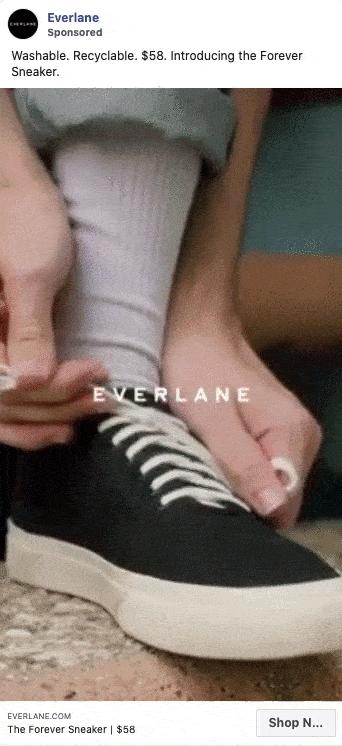 Close-up of a person tying the laces on a pair of black and white sneakers while wearing white socks. The text "EVERLANE" is displayed over the image.