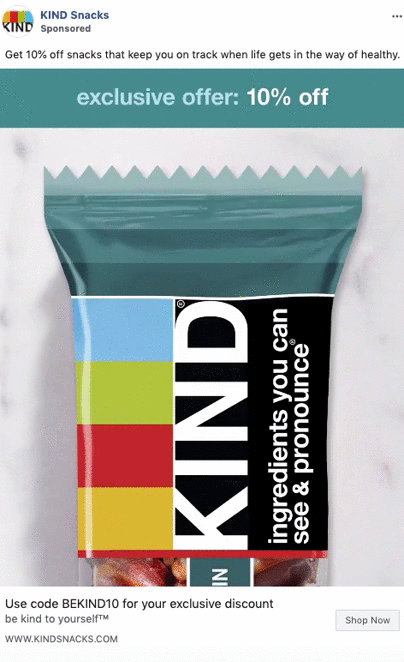 A KIND snack bar in colorful packaging is displayed with a banner reading "exclusive offer: 10% off" and a discount code for 10% off KIND Snacks.