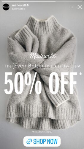 Folded gray knit sweater with white text advertising "Madewell The (Even Better) Black Friday Event 50% OFF*," plus a note about exclusions and a blue "Shop Now" button.