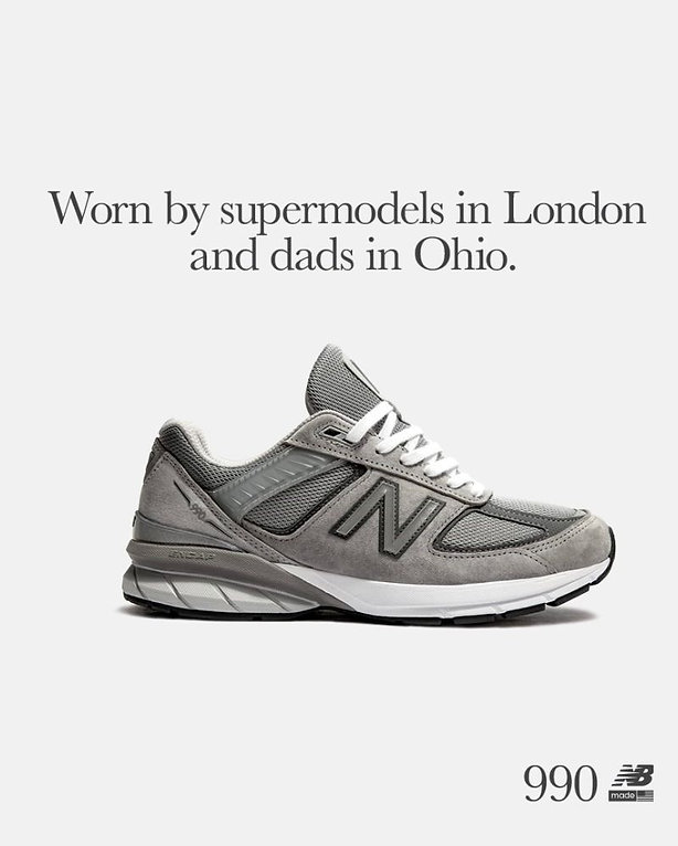 A gray New Balance 990 sneaker is displayed against a plain background with the text, "Worn by supermodels in London and dads in Ohio.