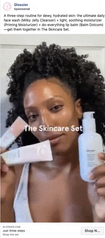 A woman holds three Glossier skincare products: a cleanser, a moisturizer, and a lip balm, with "The Skincare Set" text overlaid.