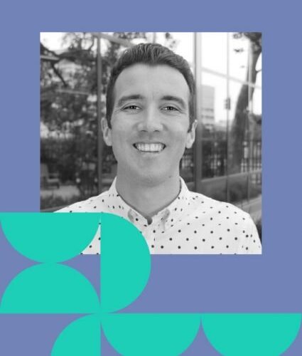 A man in a white, polka-dotted shirt smiles at the camera; black-and-white photo with geometric teal shapes and a purple border.