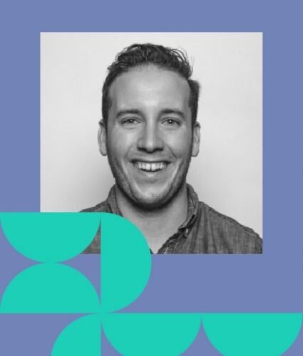 A smiling man in a button-up shirt is centered in a black-and-white photo with blue and teal geometric shapes framing the bottom and left side.