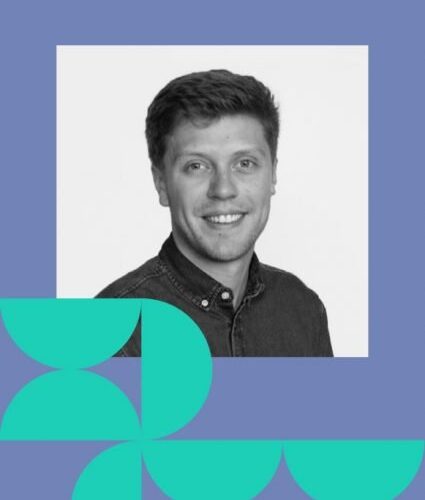 A man with short hair and a button-up shirt smiles at the camera. The photo is framed by a blue and teal geometric design.