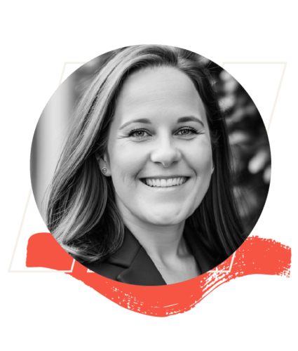 Black and white headshot of a woman with long hair, smiling, wearing a blazer, with a red graphic element below the photo.